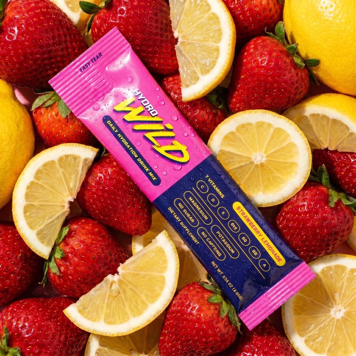 HydroWild Strawberry Lemonade packet surrounded by fresh strawberries and lemons